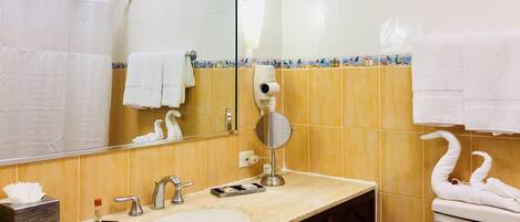 A bathroom with a sink, mirror, towel rack, and toilet.