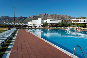 Seasonal outdoor pool, an infinity pool, pool loungers