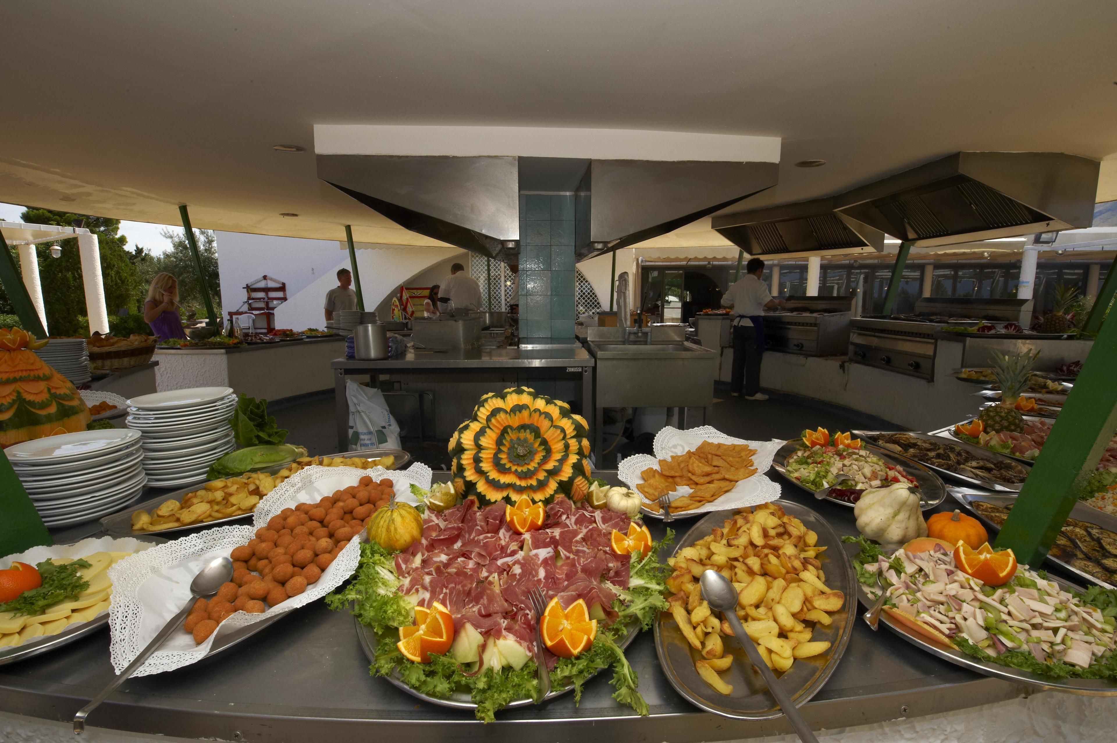 A buffet with various food items and a decorative centerpiece.