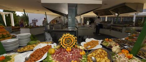 A buffet with various food items and a decorative centerpiece.