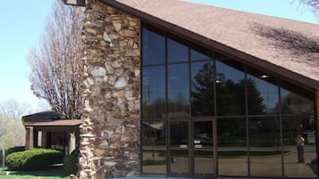 A building with a stone facade and large glass windows.