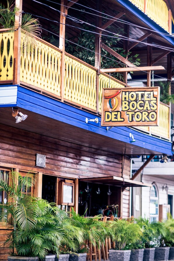 A hotel named "Hotel Bocas Del Toro" with a wooden facade, balconies, and tropical plants. - Hotel Bocas del Toro (Bocas del Toro)