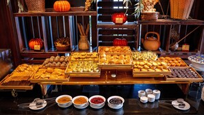 A buffet with various pastries, fruits, and bowls of sauces. - TTC Imperial Hotel (Hue)