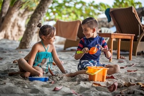 On the beach, white sand, beach towels, beach massages
