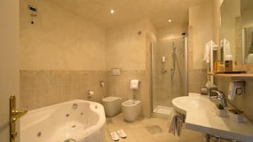 A modern bathroom with a bathtub, a shower, and a sink.