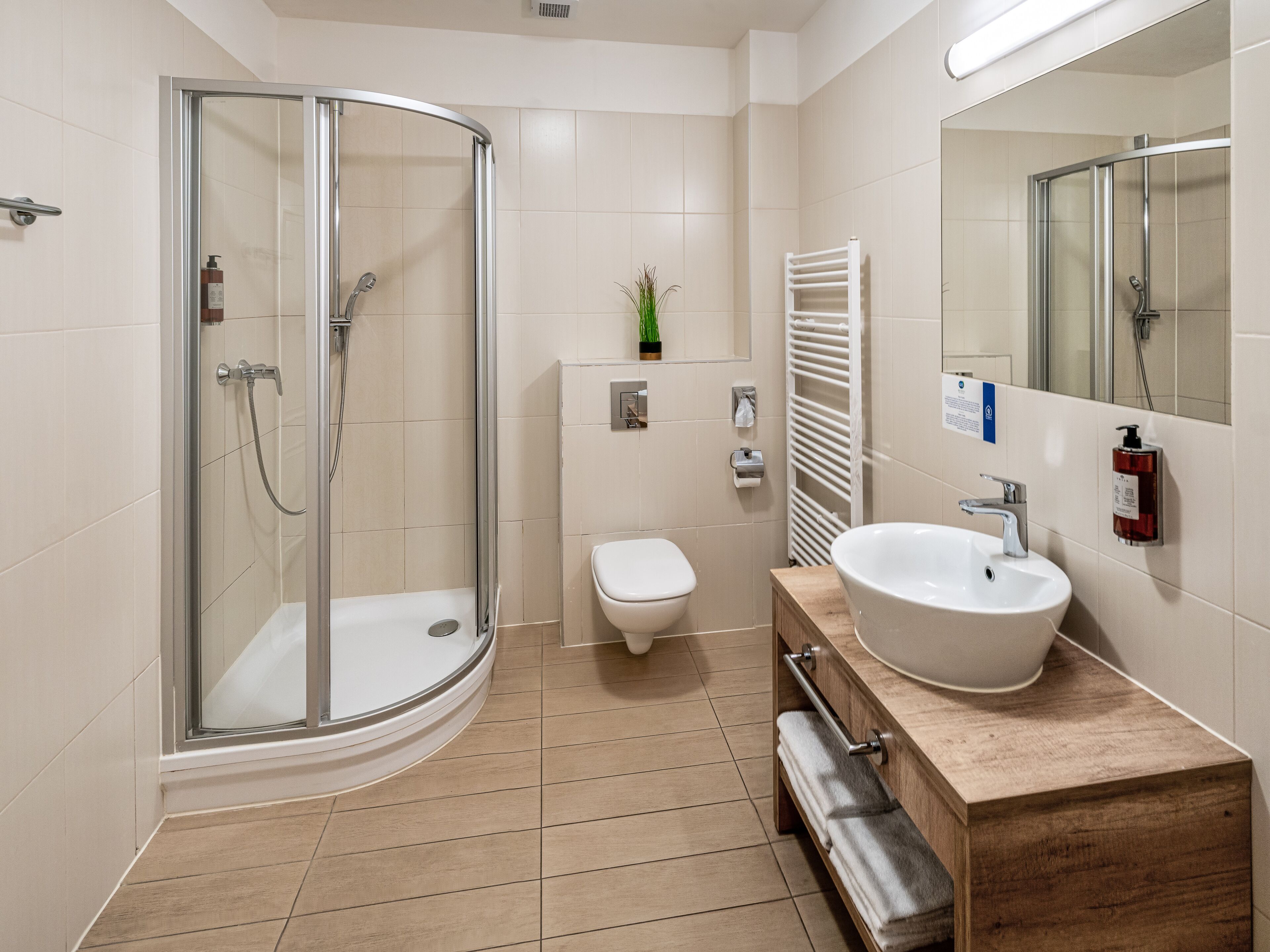 shower, designer toiletries, hair dryer, towels