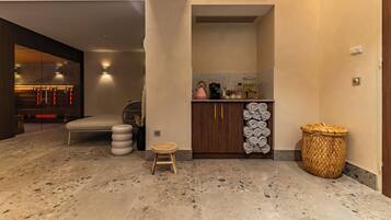 Stylish hallway leads to a cozy bedroom with a comfortable bed, bedside table, and wall-mounted shelf.