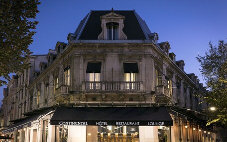 A historic building with a black awning displaying "CONTINENTAL HOTEL RESTAURANT LOUNGE".