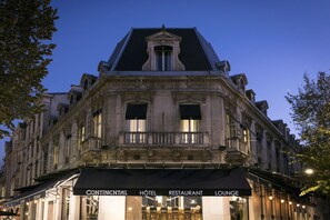 A historic building with a black awning displaying "CONTINENTAL HOTEL RESTAURANT LOUNGE".