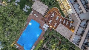 An aerial view of a hotel with a swimming pool, outdoor seating areas, and a rooftop bar. - Civitel Akali Hotel (Chania)