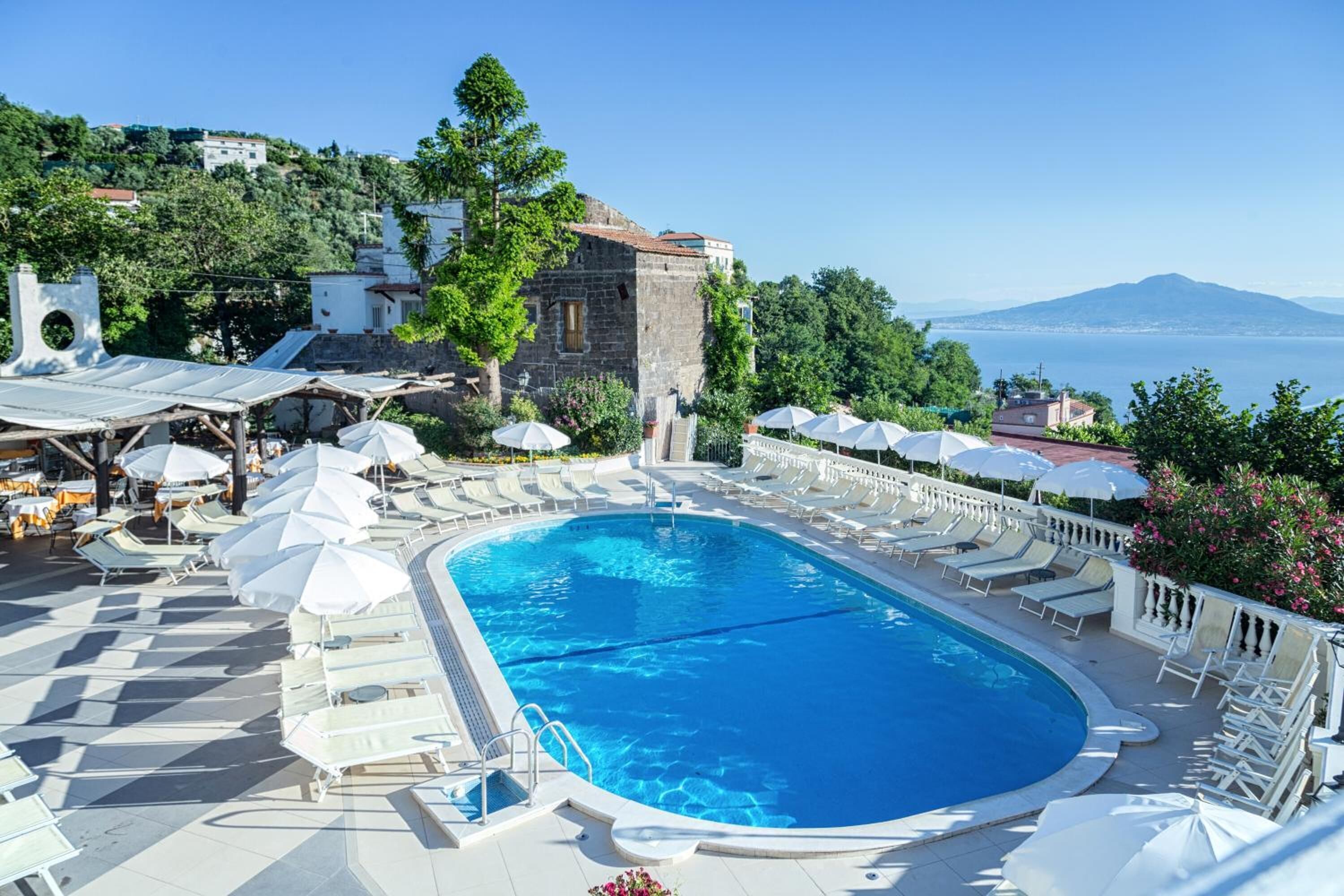 outdoor pool, open 9:00 am to 6:00 pm, pool umbrellas, pool loungers