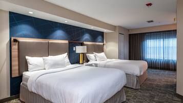 Premium bedding, desk, laptop workspace, blackout drapes