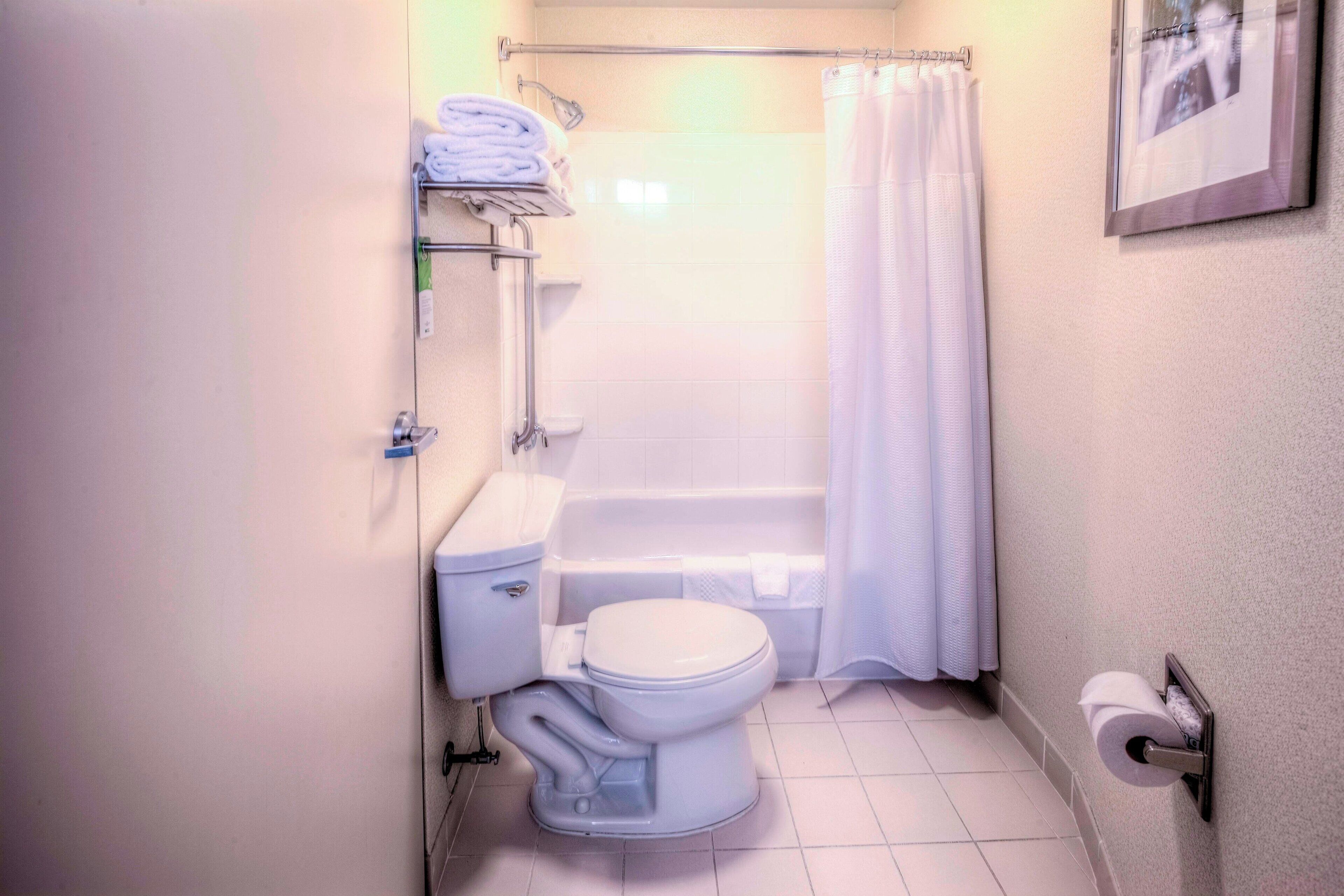 A standard bathroom with a toilet, sink, and shower area.