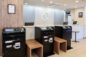 A reception desk with a logo, a television, and a small table. - Comfort Hotel Sendai East (Sendai)