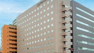 A multi-story hotel with a flat facade, numerous windows, and a sign indicating it is a Comfort Hotel.