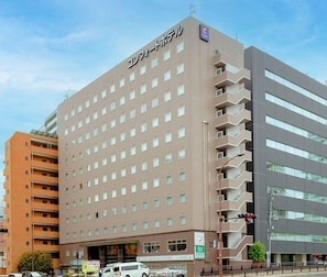A multi-story hotel with a uniform facade, multiple balconies, and a visible entrance. - Comfort Hotel Sendai East (Sendai)