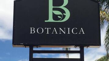 A sign for a restaurant named 'Botanica' with a large 'B' logo.
