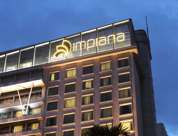 A hotel building with a prominent illuminated sign reading "Impana." - Impiana KLCC Hotel (Kuala Lumpur)