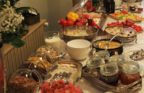 A buffet with various food items, including fruits, vegetables, and desserts. - Arc de Triomphe by Residence Hotels (Bucharest)