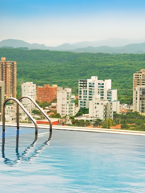 Outdoor pool, open 8:00 AM to 6:00 PM, pool umbrellas, pool loungers