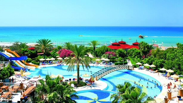A resort with a large swimming pool, a water slide, and a beach area. - Terrace Beach Resort - All Inclusive (Manavgat)