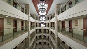 A multi-level atrium with glass railings, a central chandelier, and a symmetrical design. - Alba Royal Hotel - Ultra All Inclusive - Adults Only 16+ (Manavgat)