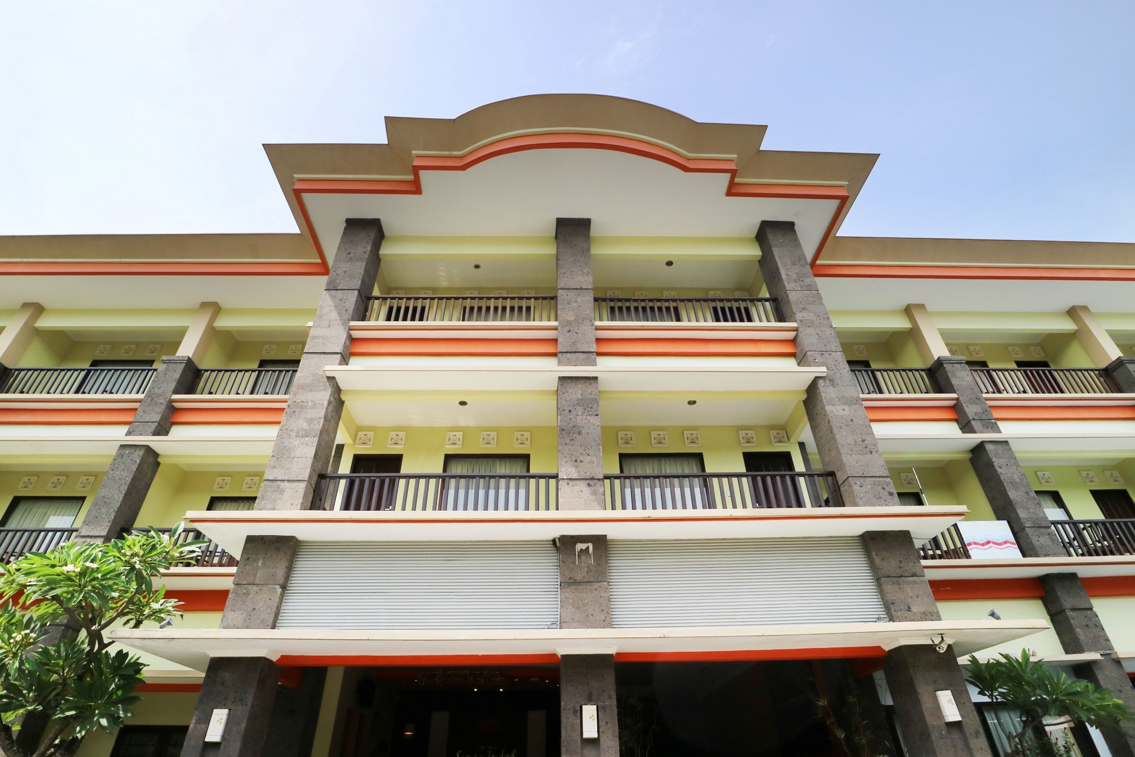 A multi-story building with a symmetrical facade, balconies, and a central entrance.