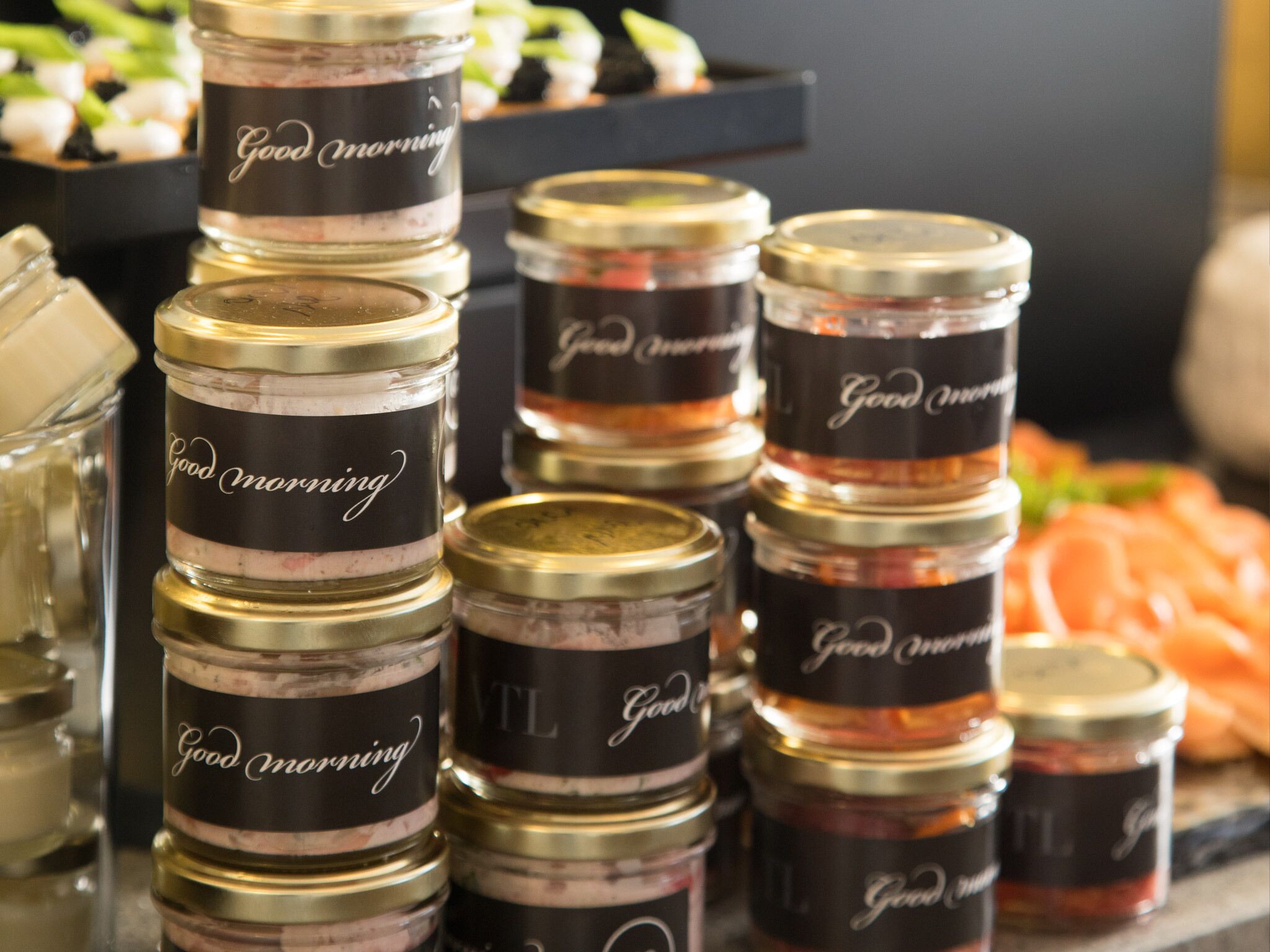 A stack of jars labeled "Good Morning" with various contents.