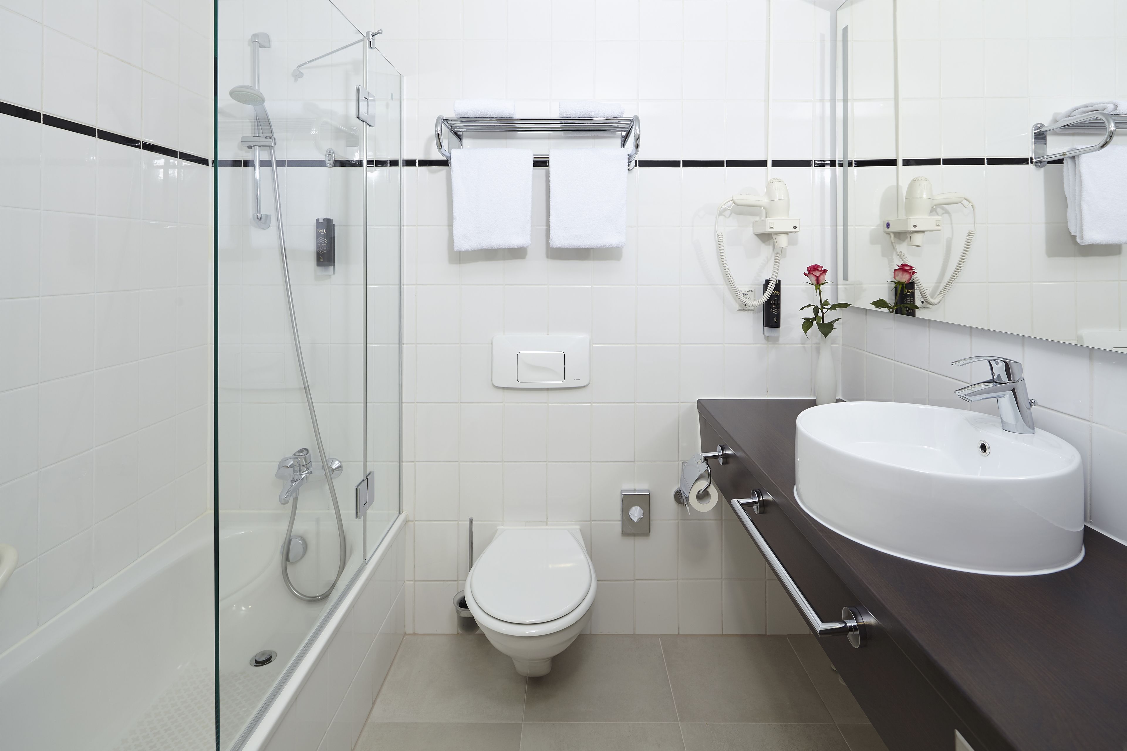 comfort room | bathroom | combined shower/bathtub, hair dryer, towels, soap