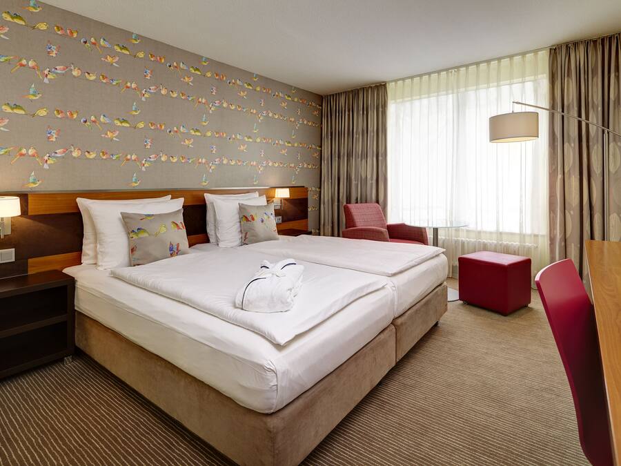 Hypo-allergenic bedding, desk, laptop workspace, blackout drapes