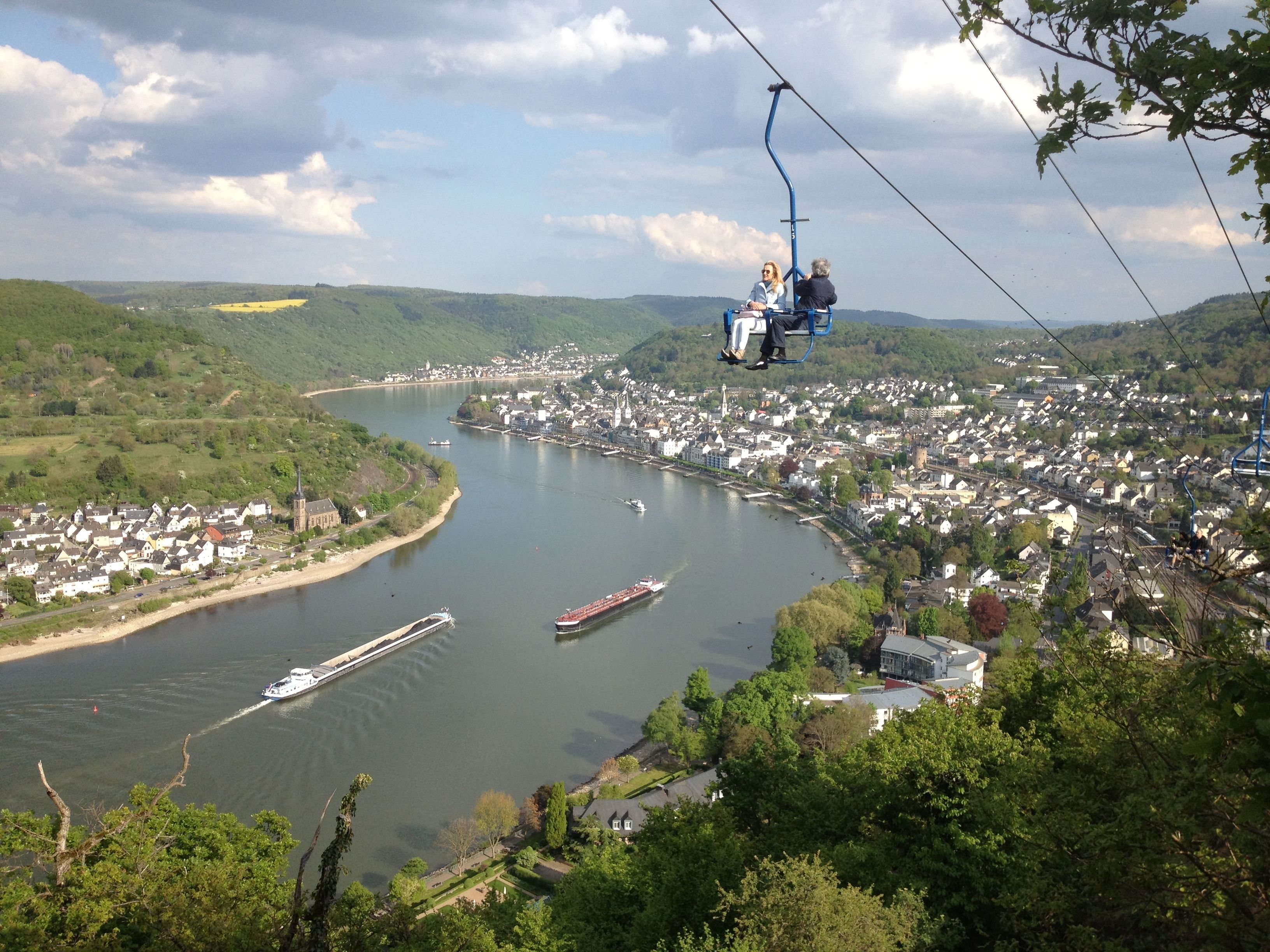 A cable car over a river with a town below.