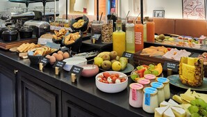 A buffet with various food items, including fruits, cheeses, and pastries. - Dadou Paris (Paris)