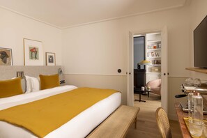 Cozy retreat with a large bed, kitchenette, and bathroom, perfect for a relaxing stay.