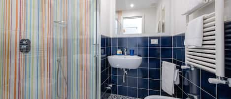 A bathroom with a shower, sink, and bathtub.