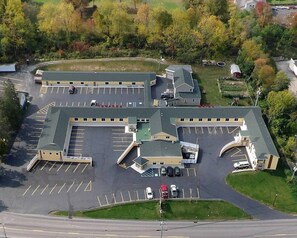 A large parking lot with multiple buildings, including a hotel and a motel.
