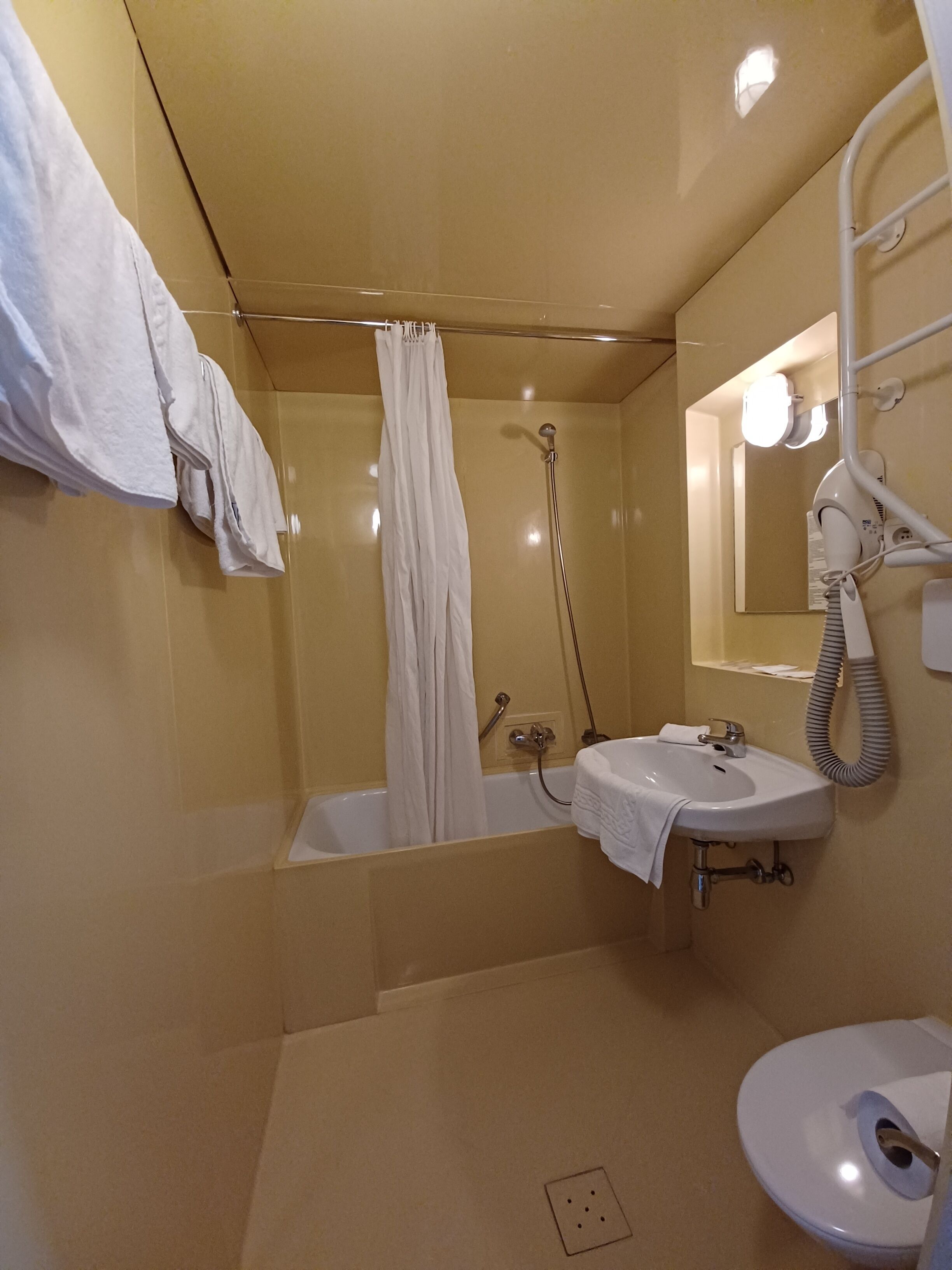 A bathroom with a bathtub, a sink, and a toilet.