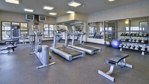 A gym with treadmills, weight machines, and free weights. - Ramada by Wyndham Camrose (Camrose)