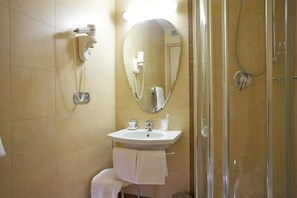 A bathroom with a sink, mirror, towel rack, and shower. - Hotel Dei Vicari (Scarperia e San Piero)