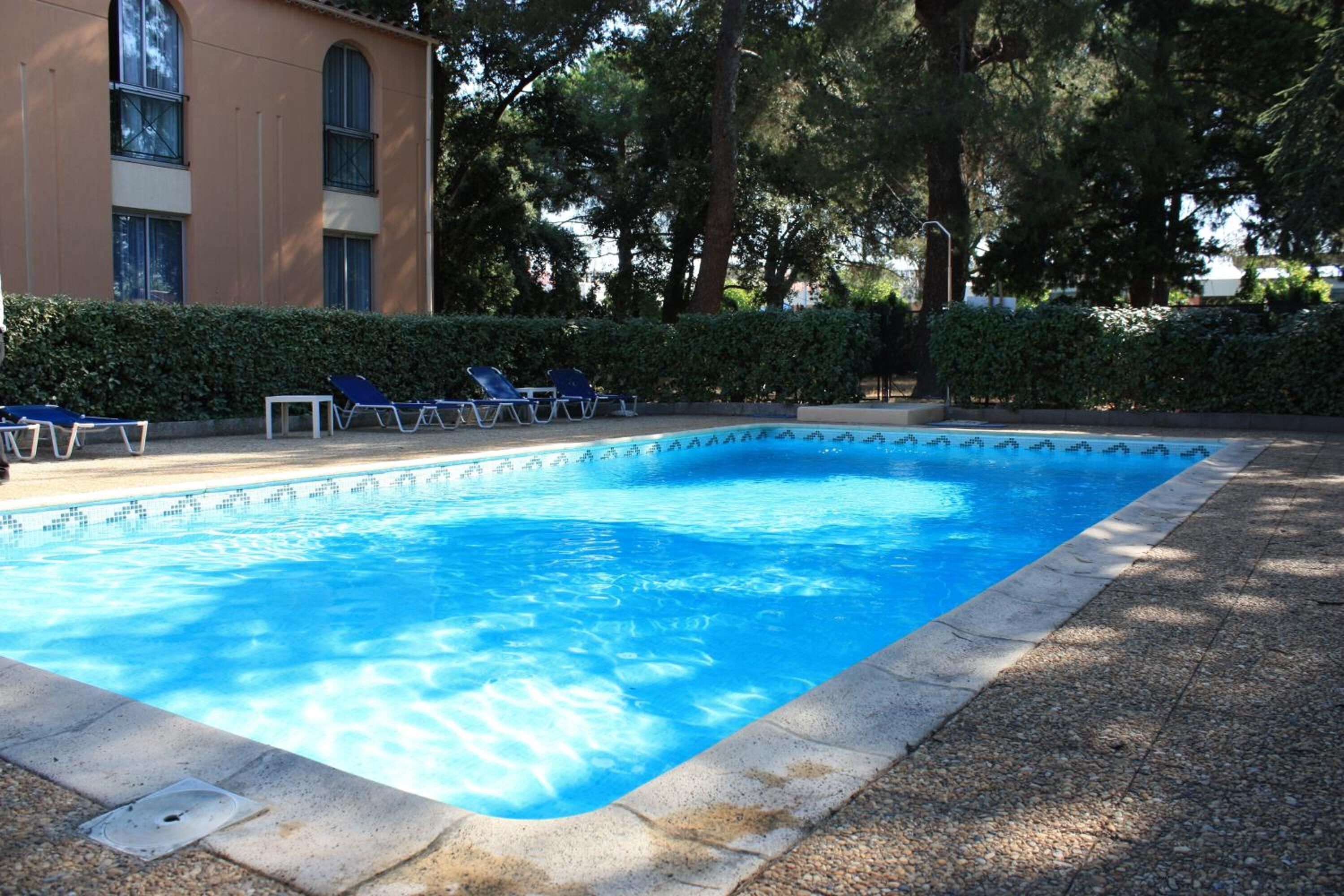 Seasonal outdoor pool, open 9:00 AM to 9:00 PM, pool loungers