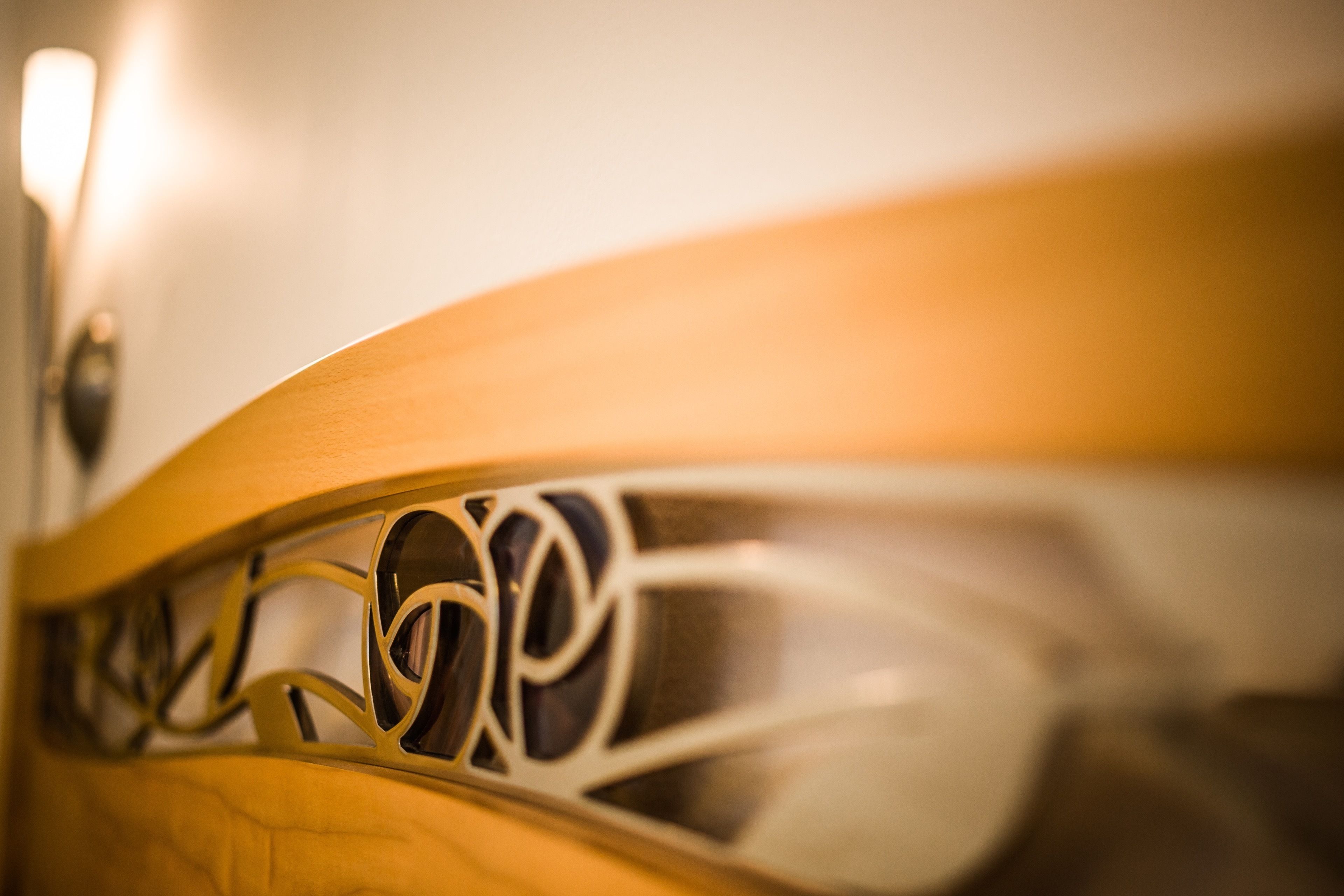 A close-up of a wooden chair with intricate carvings.