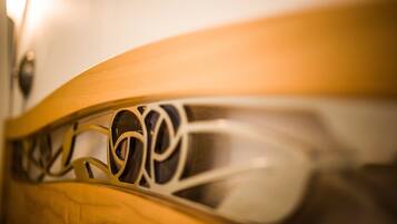 A close-up of a wooden chair with intricate carvings.