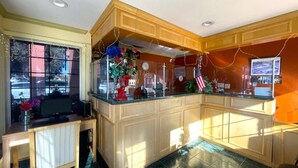 A kitchen with a wooden countertop, a sink, and a window with curtains. - Sun Star Inn Los Banos (Los Banos)
