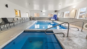 A swimming pool with a 11m3 capacity, surrounded by chairs and a covered area.