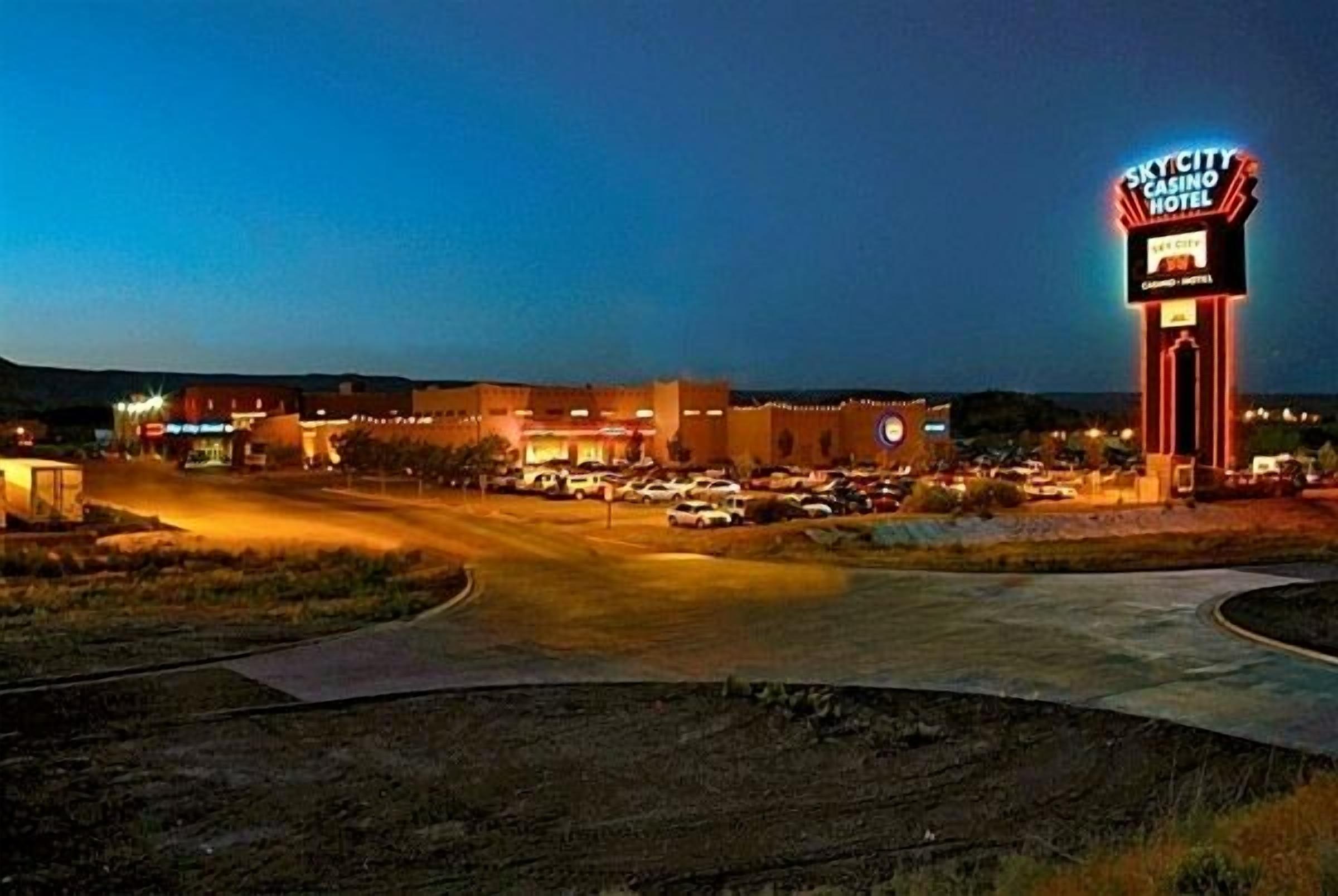 A large hotel with a prominent casino sign, multiple parking lots, and a well-lit entrance area.
