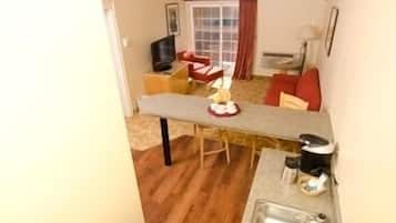 Suite, 1 King Bed, Jetted Tub | Living area | Flat-screen TV