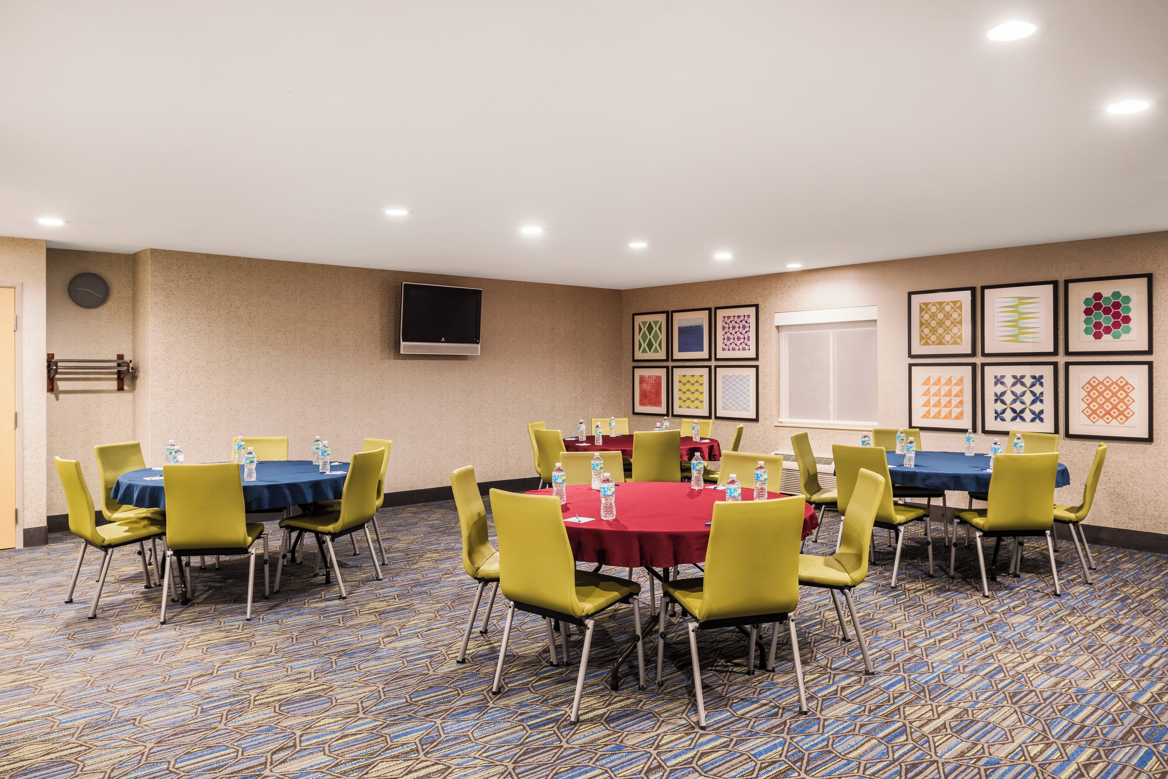 A conference room with tables, chairs, and water bottles.