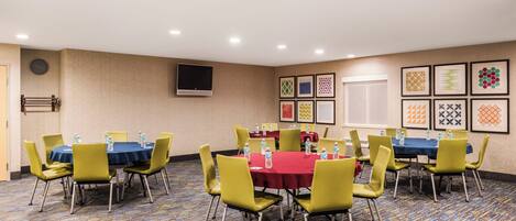 A conference room with tables, chairs, and water bottles.