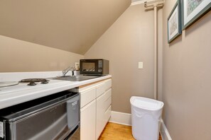 A compact kitchen with a microwave, sink, and dishwasher. - The James Place Inn B&B (Freeport)