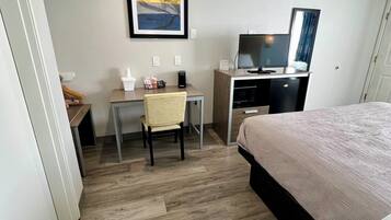 Desk, laptop workspace, blackout drapes, iron/ironing board