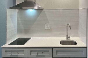 Desk, laptop workspace, blackout drapes, iron/ironing board